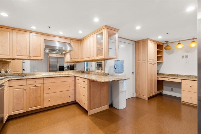 kitchen with pendant lighting, wall chimney range hood, kitchen peninsula, and light brown cabinetry