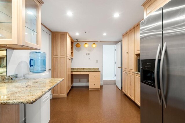 kitchen with pendant lighting, stainless steel fridge, light stone countertops, and light brown cabinets