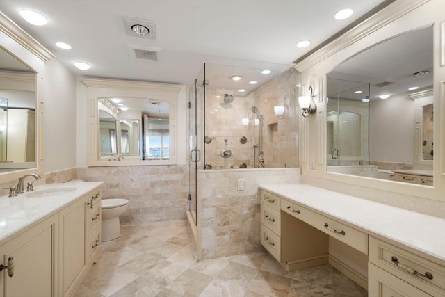 bathroom featuring vanity, an enclosed shower, tile walls, and toilet