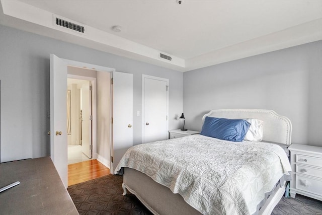 bedroom with dark wood-type flooring