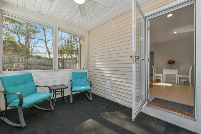 sunroom featuring ceiling fan