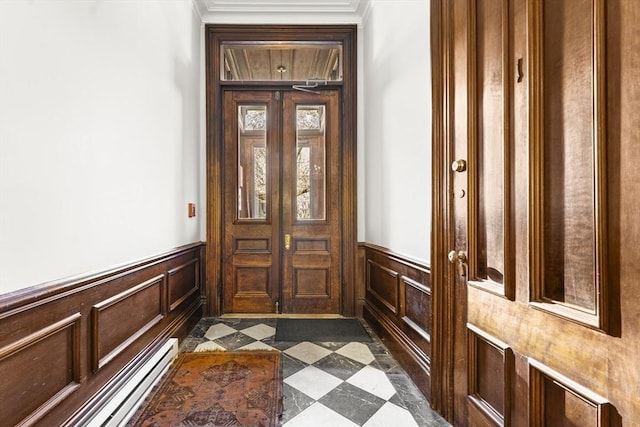 doorway featuring dark floors, a wainscoted wall, and a baseboard radiator