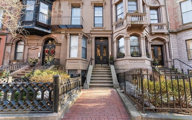 doorway to property with french doors and fence