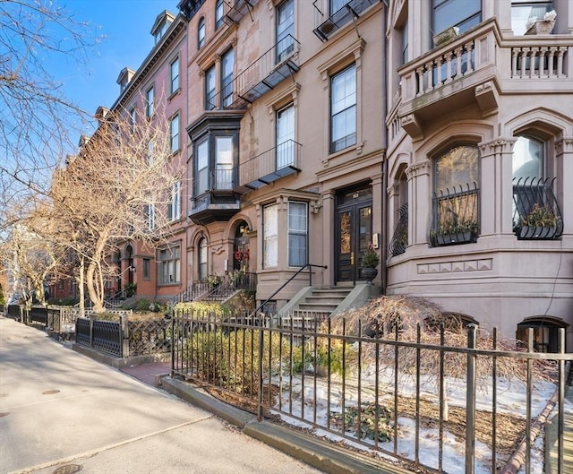 exterior space featuring a fenced front yard and a residential view