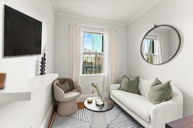 living area featuring wood finished floors, baseboards, and ornamental molding