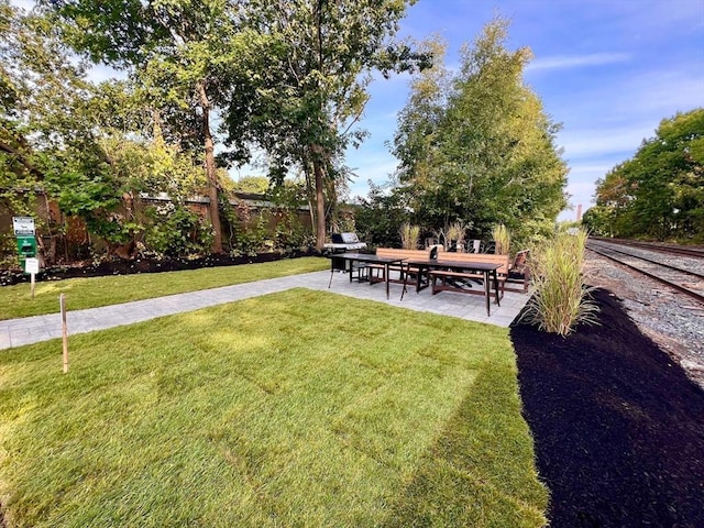 view of yard with fence and a patio