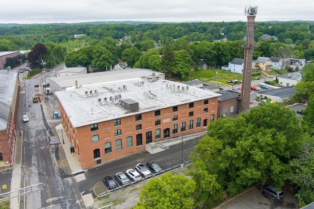 birds eye view of property with a view of trees