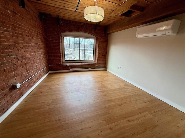 unfurnished room featuring brick wall, a wall unit AC, wood ceiling, and light wood-style floors