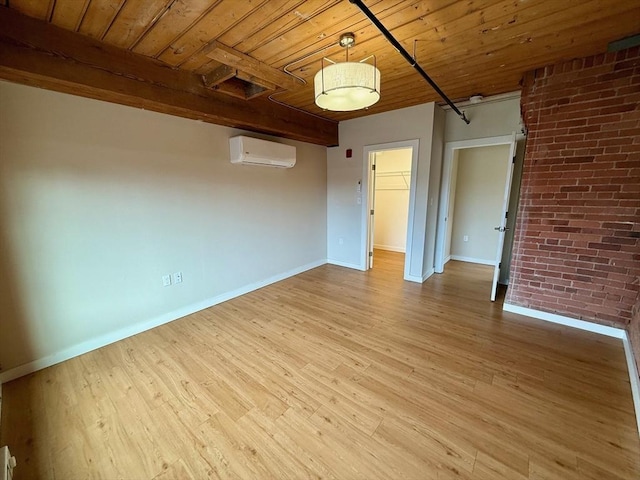 unfurnished room with light wood-style flooring, brick wall, wood ceiling, baseboards, and a wall mounted AC