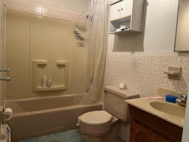 bathroom with shower / bath combo, vanity, toilet, tile walls, and decorative backsplash