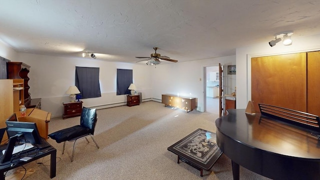 living room featuring ceiling fan, carpet flooring, and baseboard heating