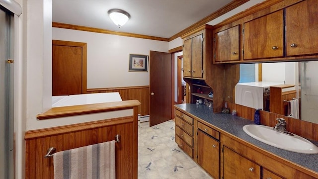 bathroom with vanity, crown molding, a baseboard radiator, and wooden walls