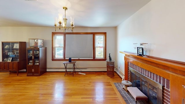 interior space with a notable chandelier, baseboard heating, and light hardwood / wood-style flooring