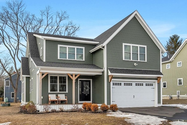 view of front facade featuring an attached garage, driveway, a porch, and roof with shingles