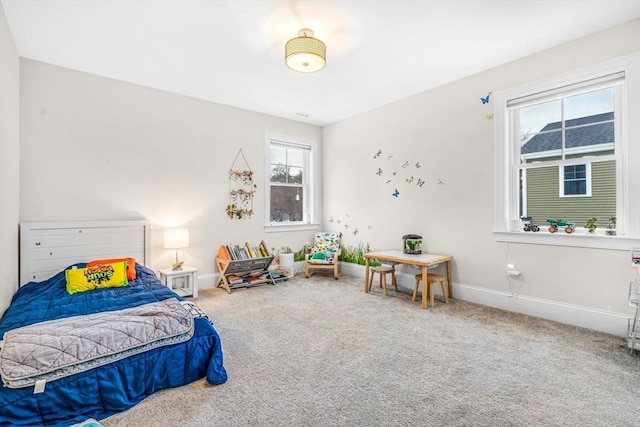 carpeted bedroom featuring baseboards