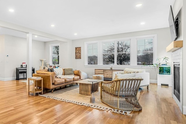 interior space featuring light wood finished floors, a fireplace, and recessed lighting