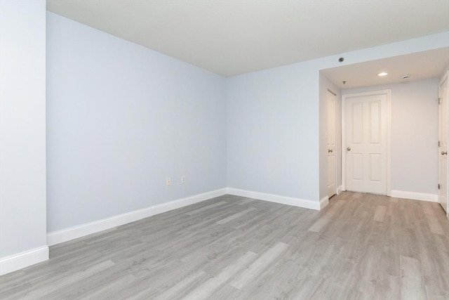 unfurnished room with light hardwood / wood-style flooring