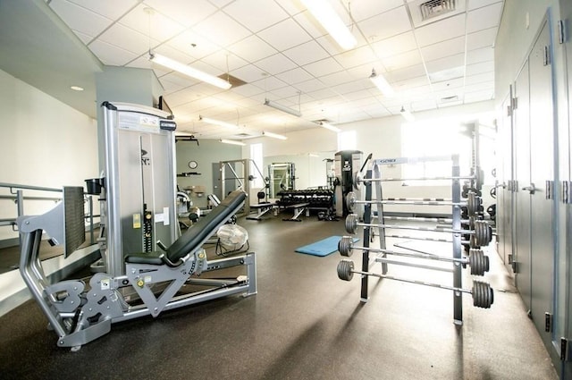 exercise room with a drop ceiling