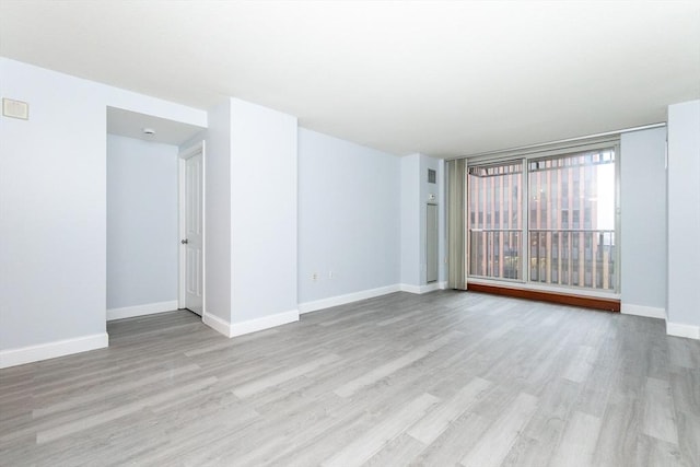 spare room featuring light wood-type flooring