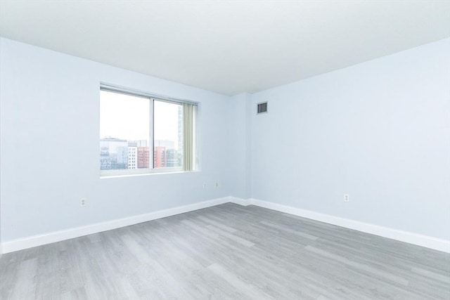 empty room with light hardwood / wood-style floors