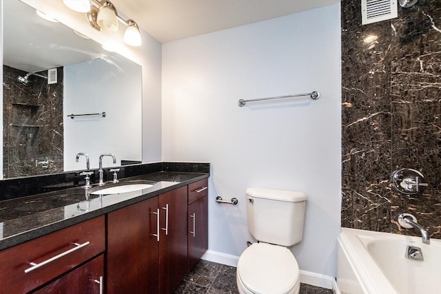 full bathroom featuring vanity, tiled shower / bath combo, and toilet