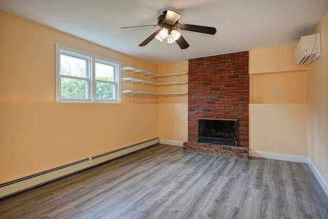 unfurnished living room with a baseboard heating unit, wood finished floors, an AC wall unit, and a ceiling fan