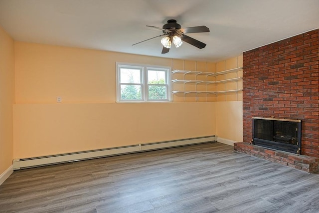 unfurnished living room featuring a baseboard radiator, a ceiling fan, wood finished floors, and a fireplace