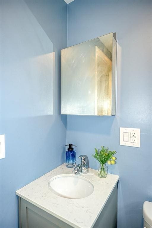 bathroom featuring toilet and vanity