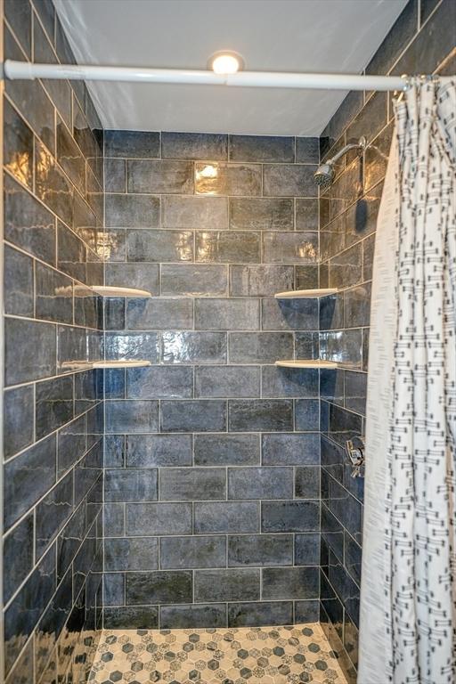 bathroom featuring a shower stall
