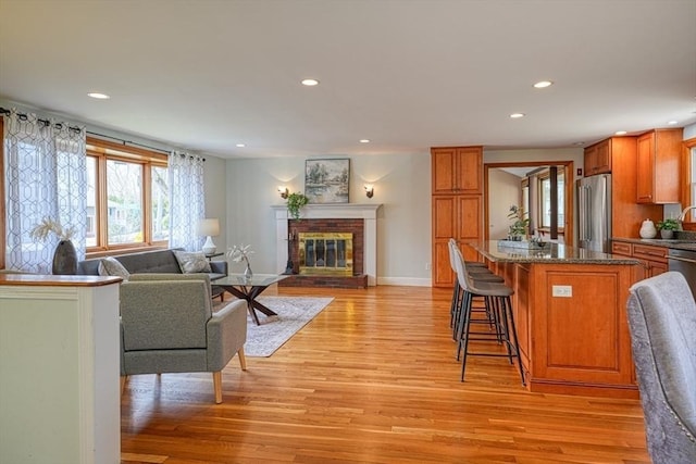 living room with recessed lighting, a wealth of natural light, and light wood finished floors