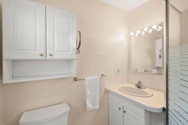 half bath featuring toilet and vanity