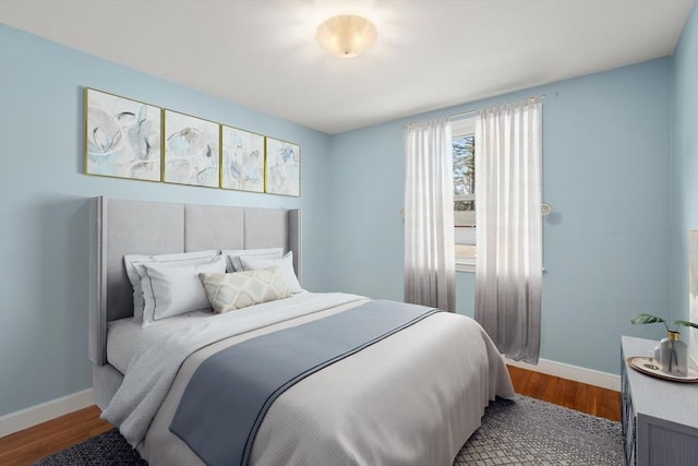 bedroom featuring wood finished floors and baseboards