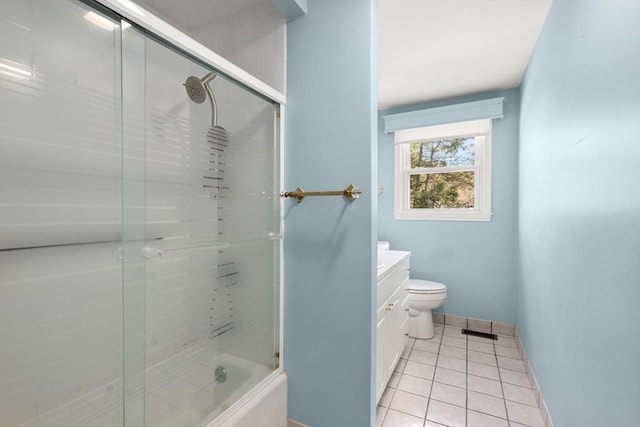 bathroom with baseboards, bath / shower combo with glass door, toilet, tile patterned floors, and vanity