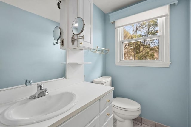 bathroom featuring tile patterned floors, toilet, and vanity