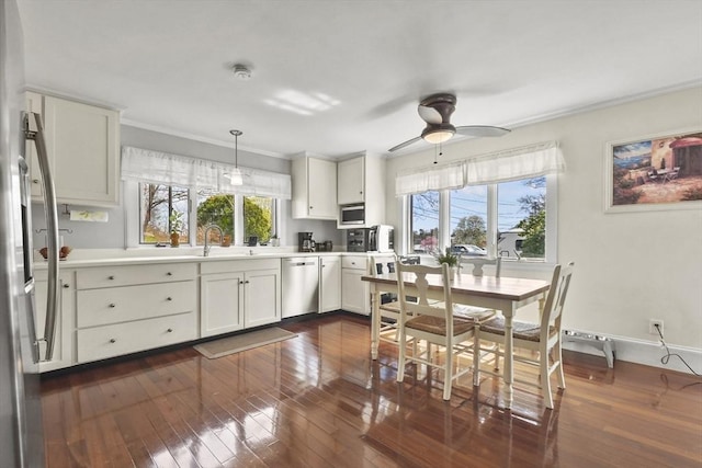 kitchen with appliances with stainless steel finishes, ceiling fan, and dark wood finished floors