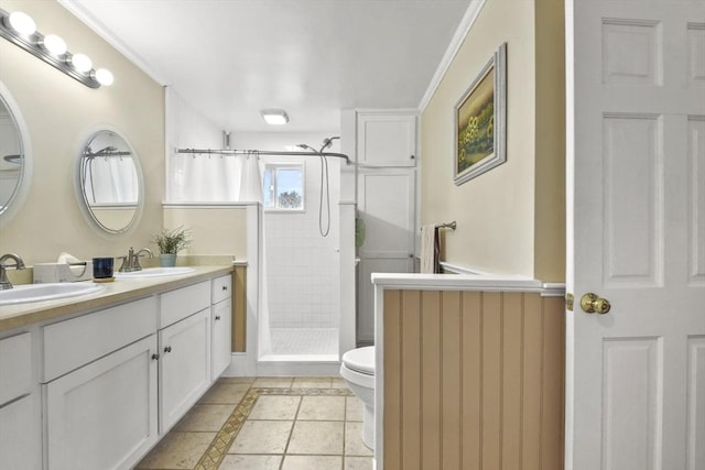 bathroom featuring double vanity, a sink, tile patterned floors, and a shower stall