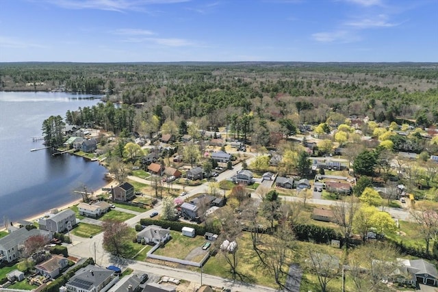bird's eye view with a water view, a residential view, and a wooded view