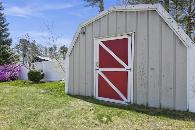 view of shed featuring fence