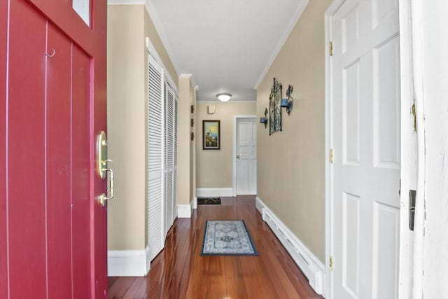 interior space featuring crown molding, baseboards, and wood finished floors