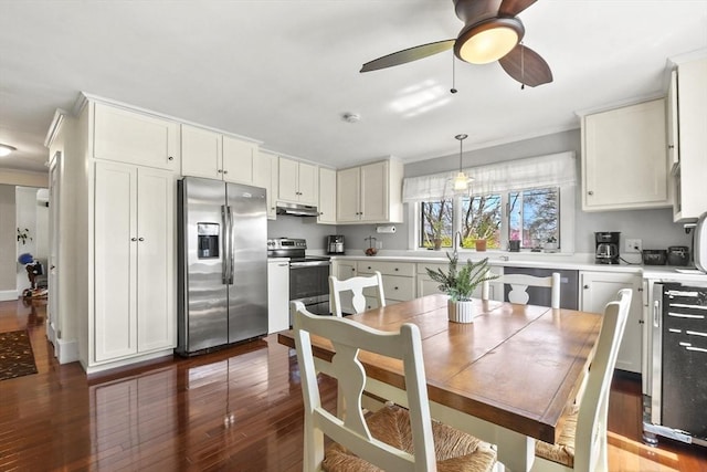 kitchen featuring ornamental molding, wood finished floors, and stainless steel appliances