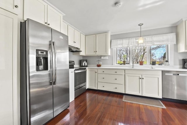 kitchen with crown molding, appliances with stainless steel finishes, light countertops, dark wood-style floors, and under cabinet range hood
