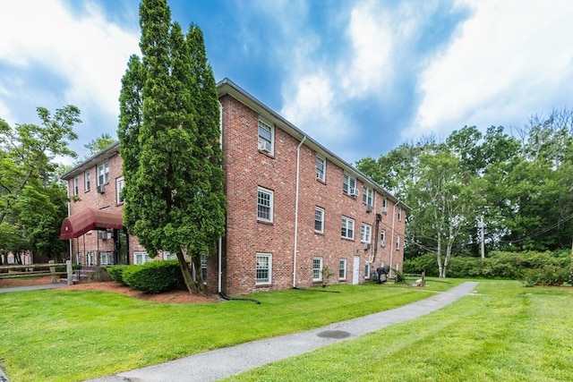 30 Danbury Dr Unit 8, Methuen, MA 01844 - view of home's exterior featuring brick siding and a yard