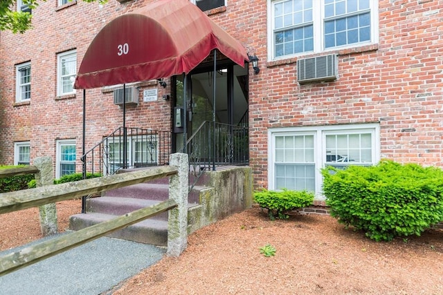 30 Danbury Dr Unit 8, Methuen, MA 01844 - view of exterior entry with a wall mounted AC and brick siding