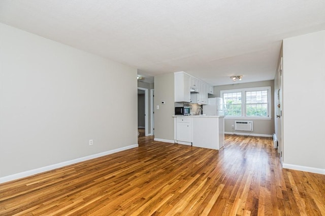 30 Danbury Dr Unit 8, Methuen, MA 01844 - unfurnished living room with light wood finished floors and a wall unit AC