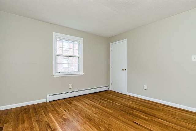 30 Danbury Dr Unit 8, Methuen, MA 01844 - empty room featuring baseboard heating and wood finished floors