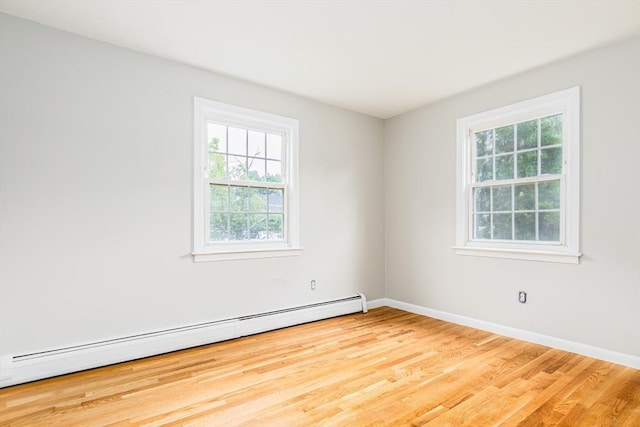 30 Danbury Dr Unit 8, Methuen, MA 01844 - empty room with a baseboard heating unit and wood finished floors