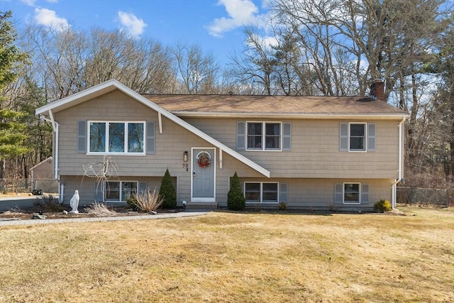 split foyer home with a front yard and a chimney