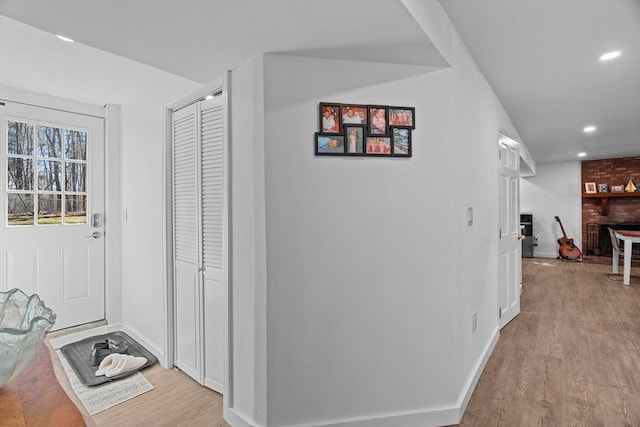 interior space featuring recessed lighting, baseboards, and wood finished floors