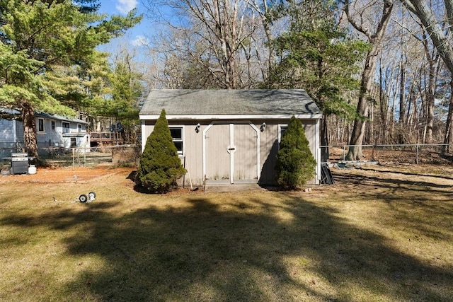 view of shed featuring fence