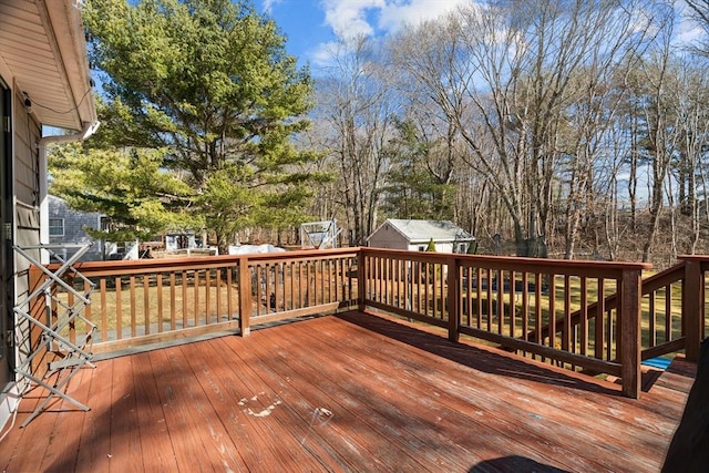 wooden terrace featuring an outdoor structure